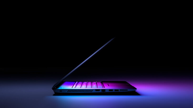 side view laptop pc with color light dark technology gaming concept